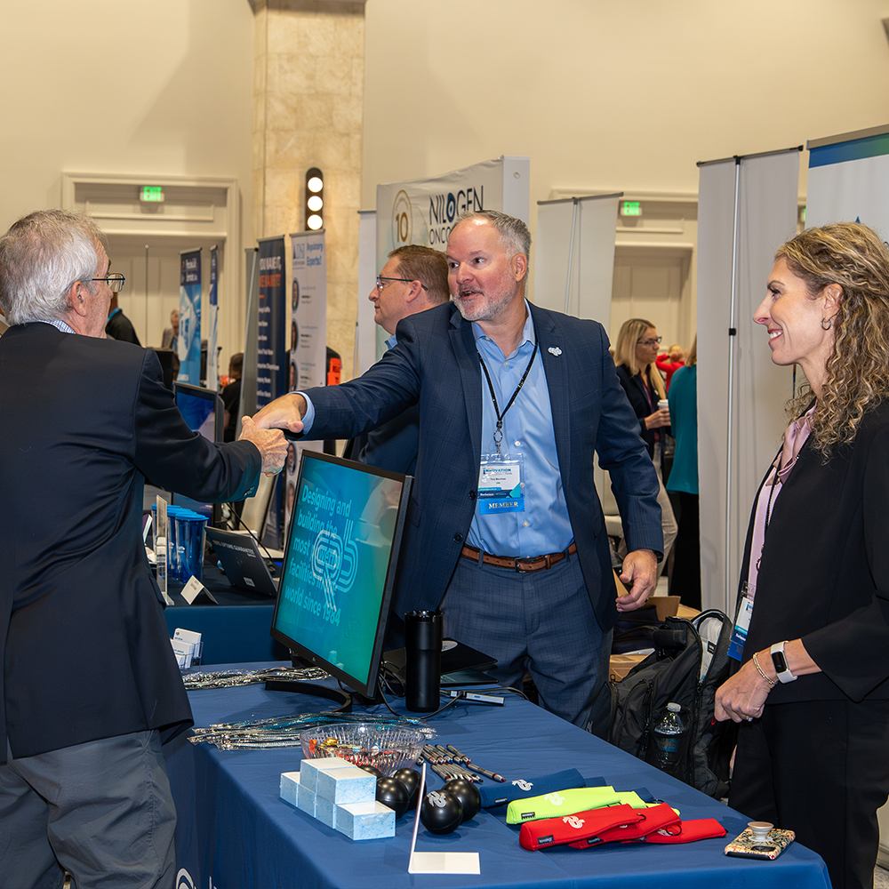 Sponsor Exhibitor talking with attendee